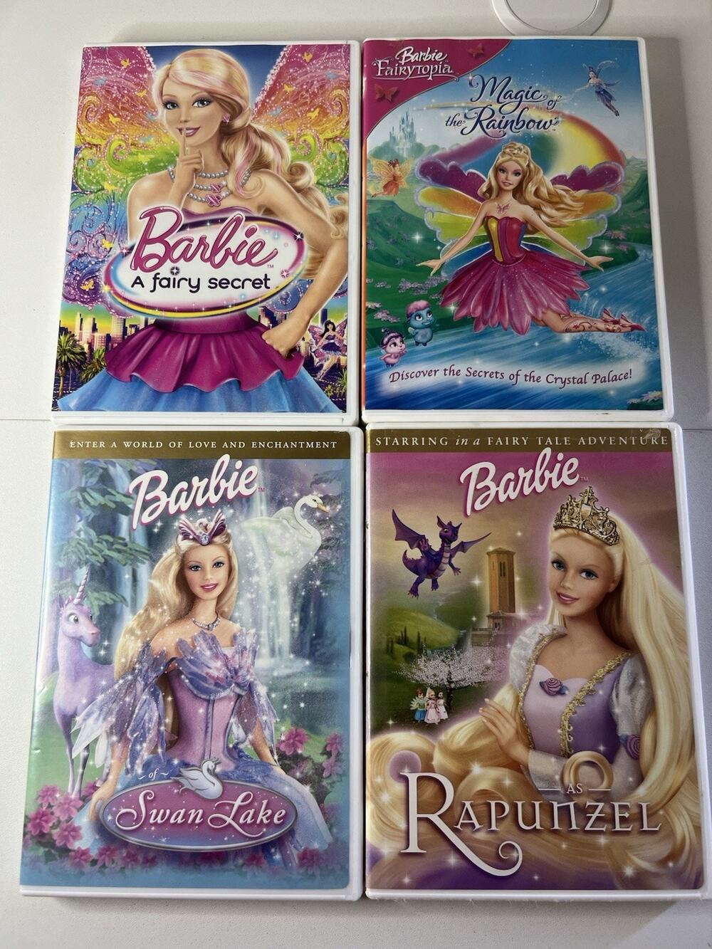 Lot of 4 Barbie DVDs - A fairy secret, Magic Of The Rainbow, Swan Lake, Rapunzel